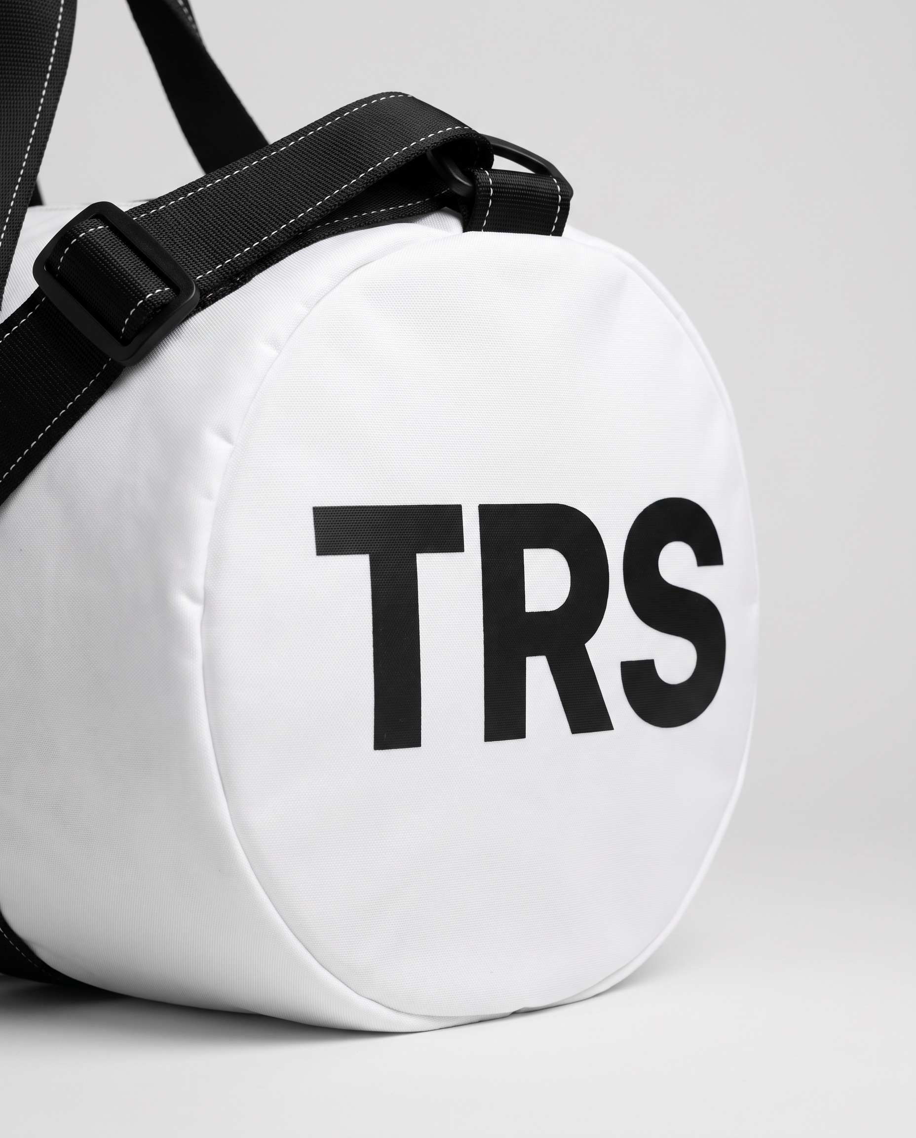 Wordmark duffle bag white — macro detail of TRS end print